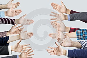 Many hands reaching sideways into