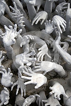 Many hands reaching up to grab