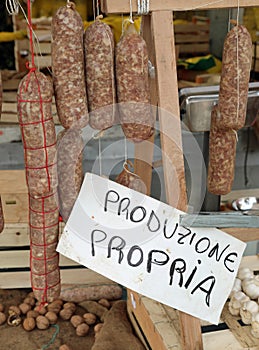 many hanged salami and the text that means own production in Ita