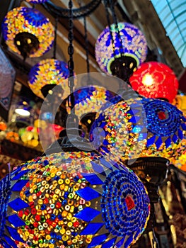 Many hanging and lit colourful and decorative Turkish glass light shades in a shop, Grand Bazaar, Istanbul, Turkey, Europe