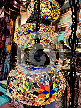 Many hanging and lit colourful and decorative Turkish glass light shades in a shop, Grand Bazaar, Istanbul, Turkey, Europe