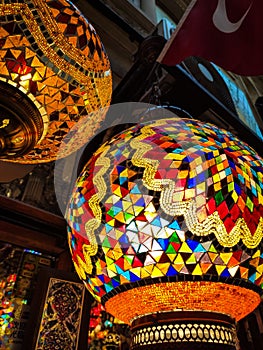 Many hanging and lit colourful and decorative Turkish glass light shades in a shop, Grand Bazaar, Istanbul, Turkey, Europe