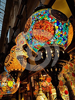 Many hanging and lit colourful and decorative Turkish glass light shades in a shop, Grand Bazaar, Istanbul, Turkey, Europe