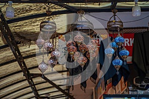 Many hanging and lit colourful and decorative Turkish glass light shades in a shop, Grand Bazaar, Istanbul, Turkey, Europe