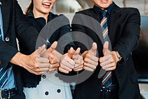 Many happy business people do thumps up sign. uds