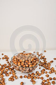 Many hazel nuts in glass bowl