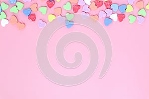 Many heart colorful on top pink background.