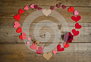 Many hearts handmade in shape of heart on the wooden board