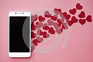 Many hearts and smartphone. Concept to like in social networks or Dating app. pink background