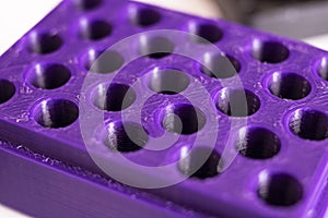 Many holes in purple plastic, concept of trypophobia