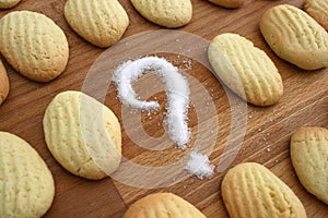 Many home made golden biscuits with a question mark