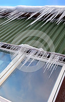 Many icicles hang on chaletÂ´s roof