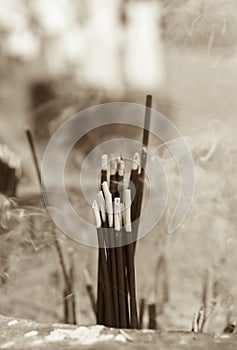 Many incense sticks burning and the smoke close up