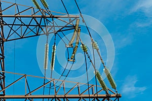 Many insulators on the wires of a tower of a high voltage power line