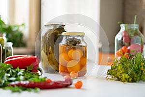 many jars with pickled vegetables mix inside, preparation for winter seasons