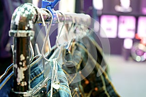 Many jeans hanging on a rack in a shop