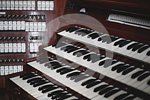 Keys and buttons on a big old brown church organ