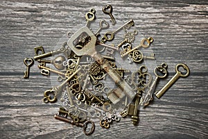 Many keys on wooden background