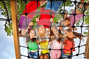 Many kids look though gridlines of playground