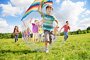 Many kids run with kite