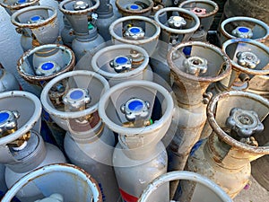 Many large metal, aluminum oxygen cylinders for breathing and diving stand on special stands on board a boat, ship, cruise liner