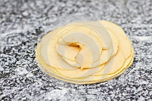 Many layers of apple slices on dough basis.