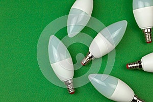 Many LED light bulbs, energy saving and eco friendly concept. Green background, flat lay, top view and copy space photo