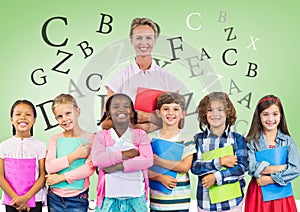 Many letters around Kids holding schoolbooks with teacher in front of green background