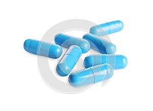 Many light blue pills isolated on white