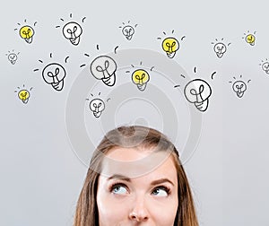 Many light bulbs with young woman