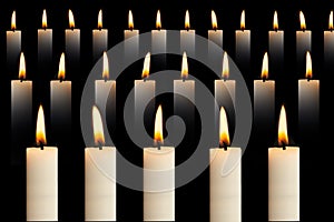 Many lit candles in rows on black background. Faith, religion, honor or spirituality concept.