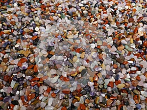 Many little colorful stones. Colorful mix of polished gemstones and minerals. Close-up