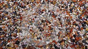 Many little colorful stones. Colorful mix of polished gemstones and minerals. Close-up