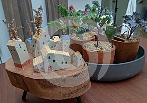 Many little houses made in wood and Kale vegetables tree planted growing in four ceramic plant pot for house decoration