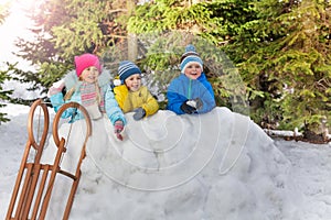Many little kids play snowball in winter park