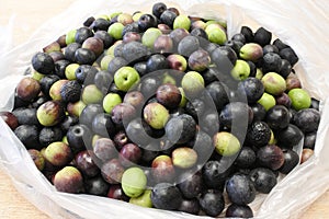 Many Manzanilla olives in a bag photo