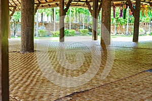 Many mats laid in a wooden pavilion