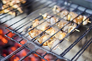 Many meat skewers barbequed on charcoal