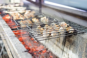 Many meat skewers barbequed on charcoal