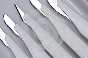 Many medical scalpels background