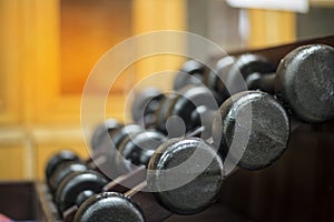 Many metal dumbbells on rack