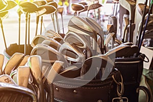 Many metal golf clubs in leather baggage