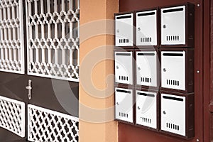 Many metal letter boxes on door outdoors