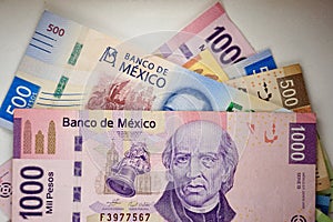 Mexican pesos bills spread randomly over a flat surface photo