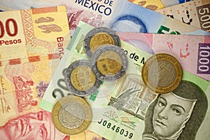 Mexican pesos bills spread randomly over a flat surface photo