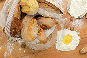 Many mixed breads in basket on the table, shot from above