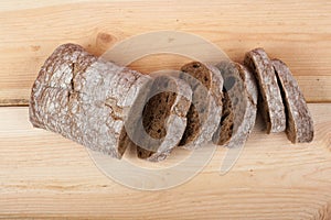 Many mixed breads and rolls of baked bread on wooden table background. Top view