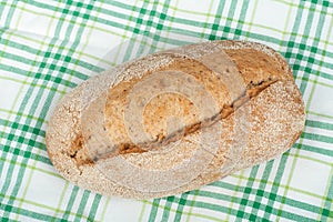 Many mixed breads and rolls of baked bread on wooden table background. Top view