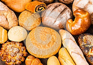 Many mixed breads and rolls shot from above photo