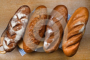 Many mixed breads and rolls shot from above. Top view of assortment of different cereal bakery